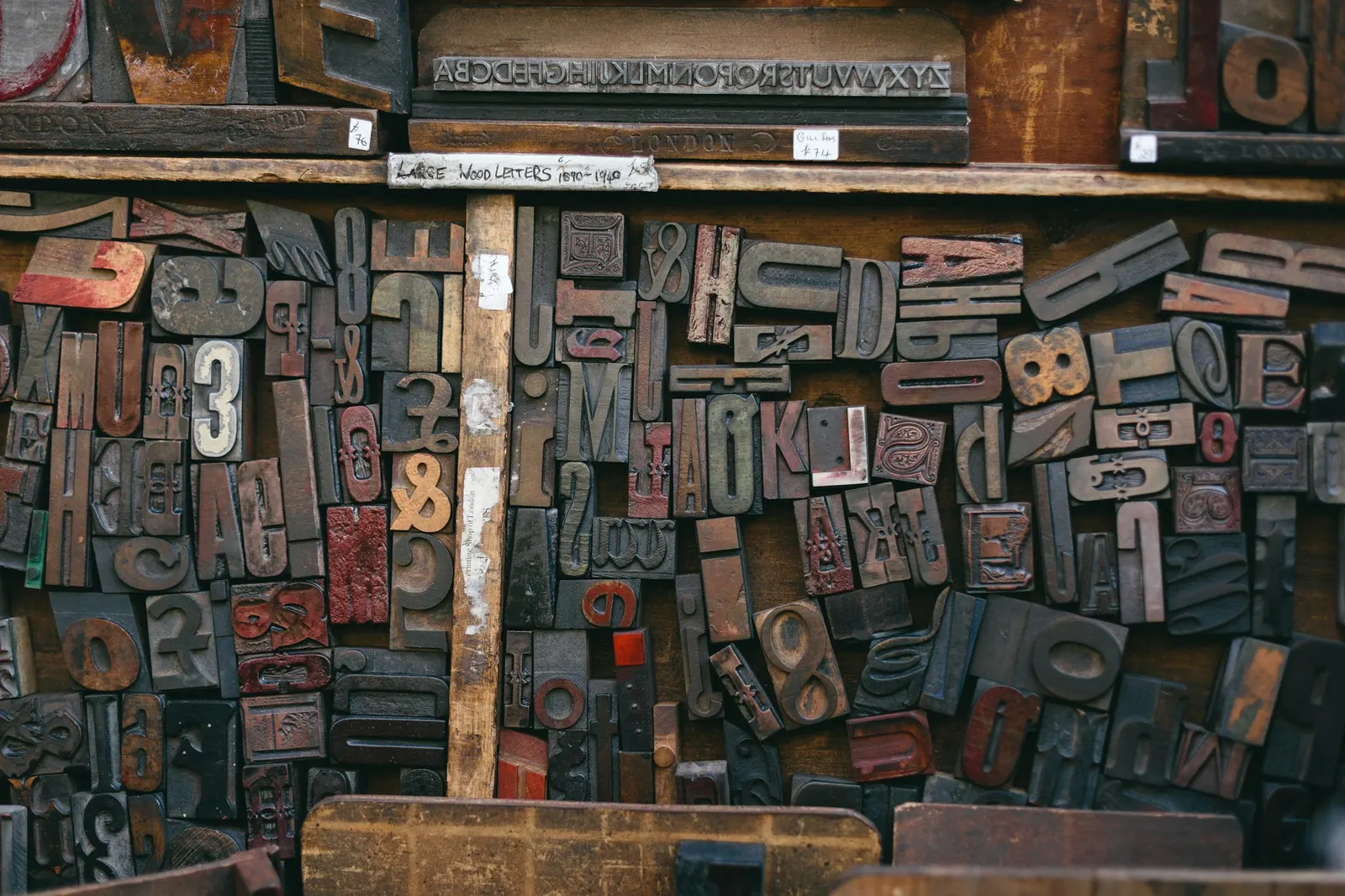 A tray of assorted vintage wooden letterpress type blocks