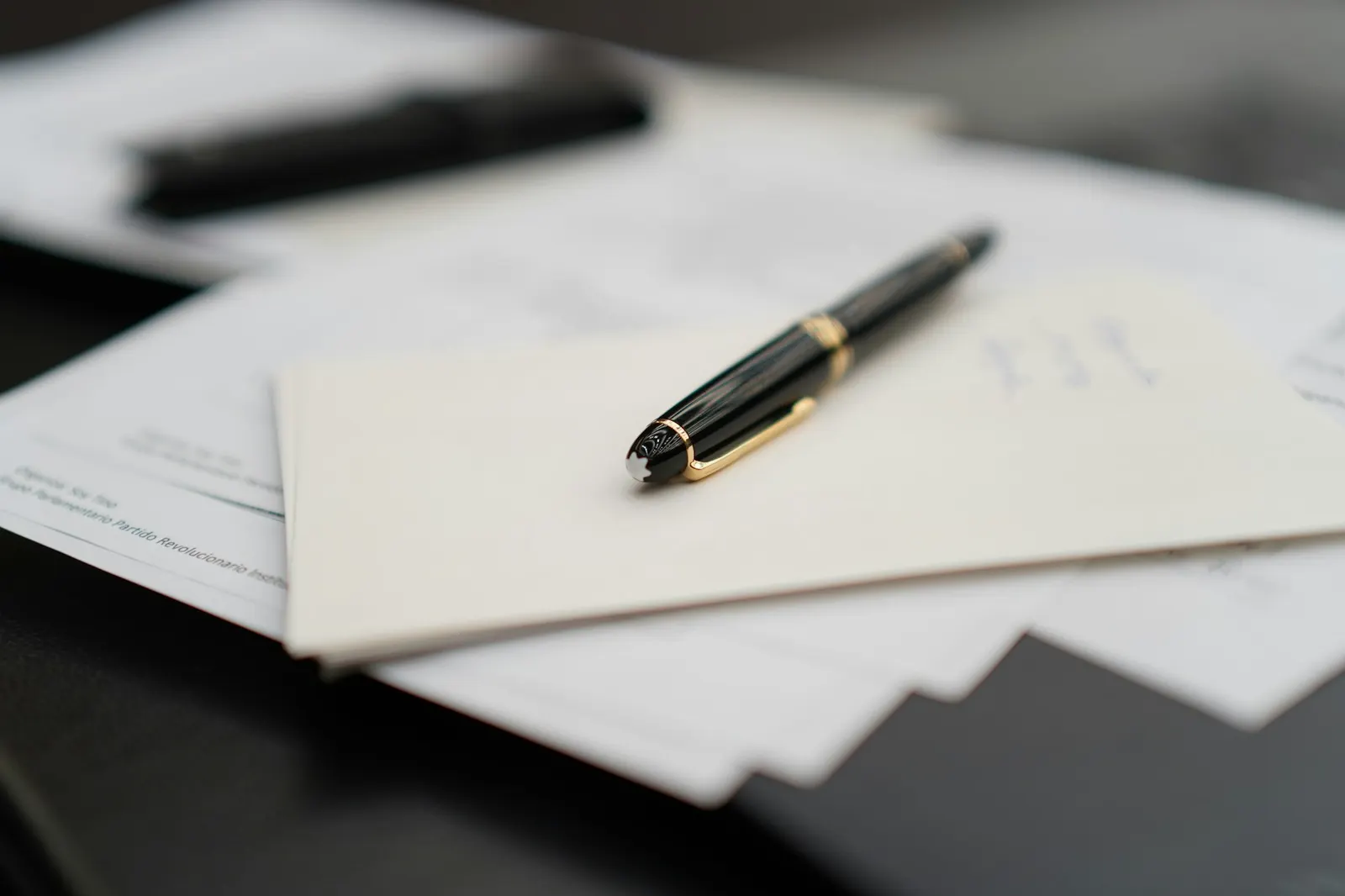 A fountain pen resting on a stack of papers, the paperwork behind a well-run influencer program