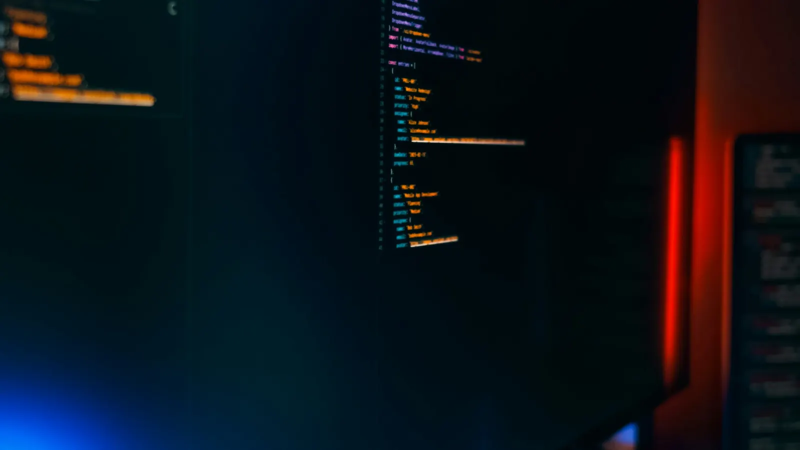 A dark computer monitor showing lines of syntax-highlighted code, the kind of plain-text file llms.txt is