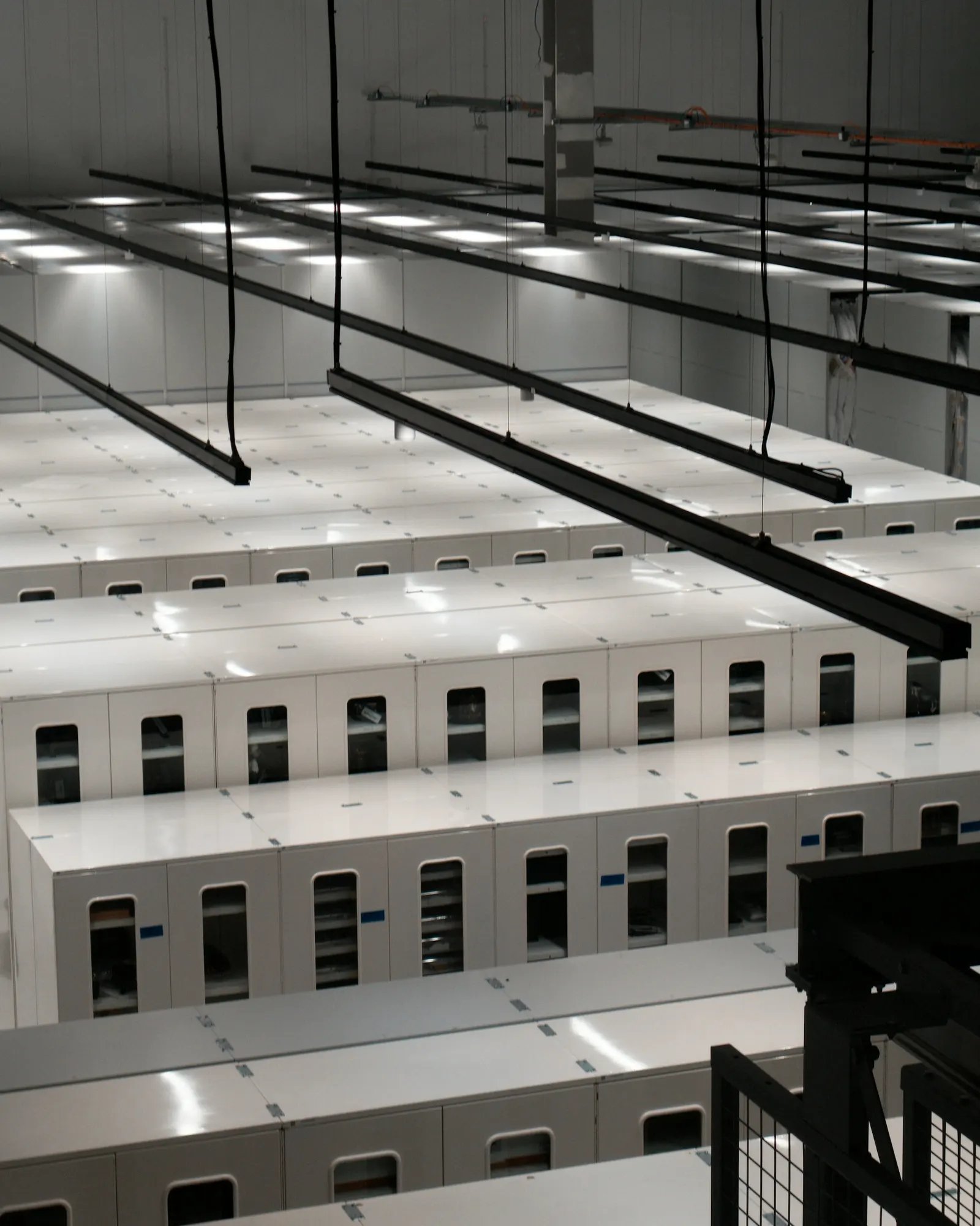 Rows of white server cabinets in a modern data center