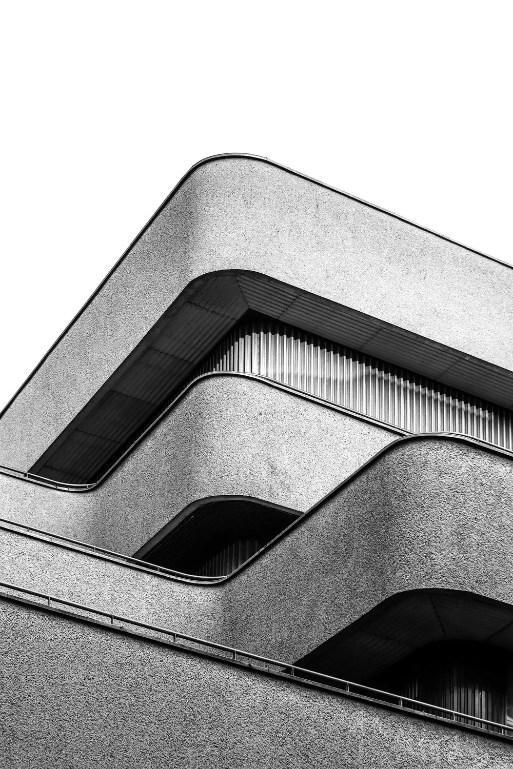 Curved concrete balconies forming clean geometric lines, in black and white