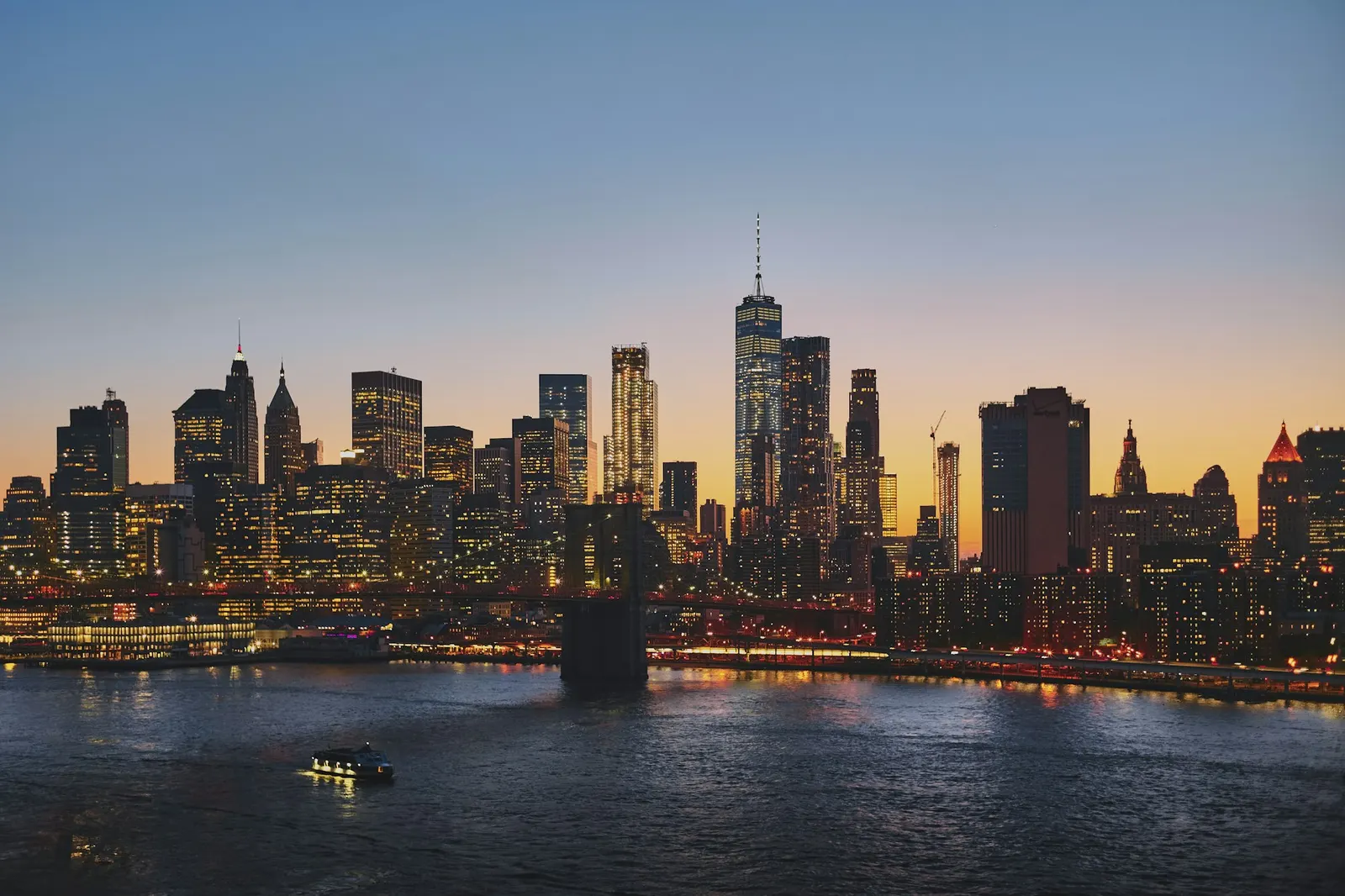 Lower Manhattan skyline and the Brooklyn Bridge at dusk